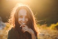 Beautiful young woman smiling on beautiful landscape in sunset time. Royalty Free Stock Photo