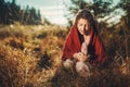 Beautiful shaman woman in nature and ceremony of the earth. Woman holding a large crystal of rosary in her hands.