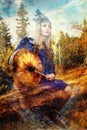 Beautiful shamanic girl playing on shaman frame drum in the nature. Computer collage and painting effect. Royalty Free Stock Photo