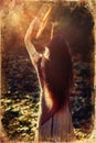 Beautiful shamanic girl playing on shaman frame drum in the nature, old photo effect Royalty Free Stock Photo