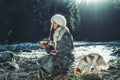 Beautiful shamanic girl playing on tibetian bowl in the nature.