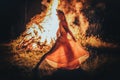 beautiful shamanic woman dancing by the fire.