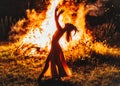 beautiful shamanic woman dancing by the fire.