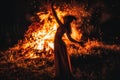 beautiful shamanic woman dancing by the fire.