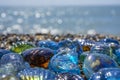Beautiful shape glass and stones on the seashore. Azure clear sea water with waves. Green, blue shiny glass with multi