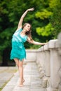 Beautiful shapely woman in a turquoise dress dancing Royalty Free Stock Photo