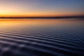 Beautiful and sharp water ripples on Trasimeno lake Umbria, Italy at dusk