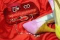 Beautiful shining accessories and high-heeled shoes and a red clutch on the evening dress