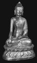 Beautiful shining classical Buddha Shakyamuni. Siddhartha Gautama. Golden statue with open eyes isolated on the black