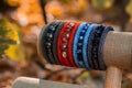 Beautiful, shiny, color bracelet with large beadwork beads. On a special stand for jewelry. Brown autumn foliage on the background Royalty Free Stock Photo