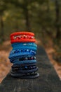 Beautiful, shiny, colorful bracelet set with large beadwork beads. On a wooden bench in the park. Jewelry on hand Royalty Free Stock Photo