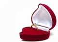 Beautiful shiny gold ring with a large diamond of high quality. In a red velvet box in the shape of a heart. Red Royalty Free Stock Photo