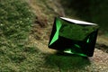 Beautiful shiny green gemstone on stone, closeup. Space for text Royalty Free Stock Photo