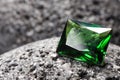 Beautiful shiny green gemstone on stone, closeup. Space for text Royalty Free Stock Photo