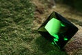 Beautiful shiny green gemstone on stone, closeup. Space for text Royalty Free Stock Photo