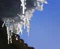 Beautiful shiny icicles melt and drip on the roof in the spring Royalty Free Stock Photo