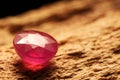 Beautiful shiny pink gemstone on stone, closeup. Space for text Royalty Free Stock Photo