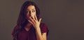 Beautiful shock surprising brunette business woman looking with open mouth covering the hand and big eyes in red silk blouse on Royalty Free Stock Photo