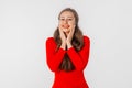 Beautiful shocked and surprised woman with open mouth. Amazed girl holds cheeks by hand, stand over white studio background. Royalty Free Stock Photo