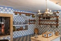 Beautiful shor of an antique kitchen with tile walls with patterns and old tableware