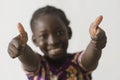 Beautiful African girl showing thumbs up, isolated on white