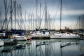 Beautiful shot of anchored sailboats in the harbor with reflections on the water Royalty Free Stock Photo