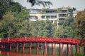 Beautiful shot of an ancient red bridge over water in Vietnam Royalty Free Stock Photo