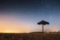 Beautiful shot of a beach at an evening with circular star trail in the sky