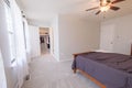 Beautiful shot of a bedroom with a double size bed, closet, and a ceiling fan with light Royalty Free Stock Photo