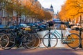 Beautiful shot of bikes parked on a bridge over a canal in Amsterdam Royalty Free Stock Photo