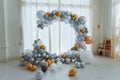 Beautiful shot of a birthday photo corner made from gray, white and orange balloons