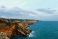 Beautiful shot of the blue sea and cliffs on a cloudy day Royalty Free Stock Photo