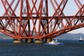 Beautiful shot of boats under The Forth Bridge