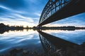 Beautiful shot of a bridge over a reflective lake during the sunset Royalty Free Stock Photo