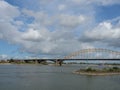 Beautiful shot of a bridge at the Waal river under blue cloudy sky in Nijmegen, Netherlands