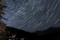 Beautiful shot of brightly glowing meteor showers in the sky over the mountains at night Royalty Free Stock Photo