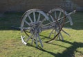 Beautiful shot of a broken wooden wagon wheels on a grassy area outdoors Royalty Free Stock Photo