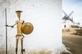 Beautiful shot of the bronze Don Quijote sculpture near the white windmill wall in Consuegra, Spain