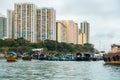 Beautiful shot of buildings with boats on the water in Aberdeen harbor, Hong Kong