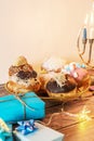 Beautiful shot of a burning Menorah lampstand next to pastry in celebration of Hanukkah