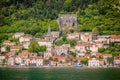 Beautiful shot of a castle and house buildings on the beach of Montenegro with the look of the ocean