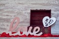 Beautiful shot of a cute room decor of the word Love, a heart and a wooden casket Royalty Free Stock Photo