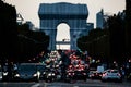 Beautiful shot of a cyclist in front of the Triumphal Arch during the traffic