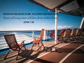 Beautiful shot of a deck of a modern ship with wooden chairs and a biblical quote written