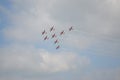 Beautiful shot of eight warplanes in the sky going in the same direction.