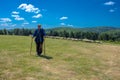 Beautiful shot of an elderly shepherd near his herd of sheep on a meadow Royalty Free Stock Photo