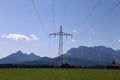 Beautiful shot of an electrical pylon tower in the middle of a field Royalty Free Stock Photo