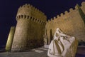 Beautiful shot of a female marble statue in front of the Segovia castle walls in Spain