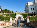 Beautiful shot of a female walking down the stairs of Miramare Castle in Gulf of Trieste, Italy