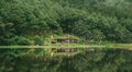 Beautiful shot of forest and cabin reflections on the pond Royalty Free Stock Photo